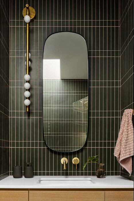 Regan Baker terraced Piedmont powder room with dark green tile and contrasting dusty pink grout.