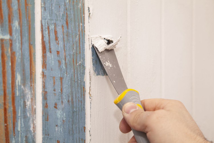 Scraping paint off a wall