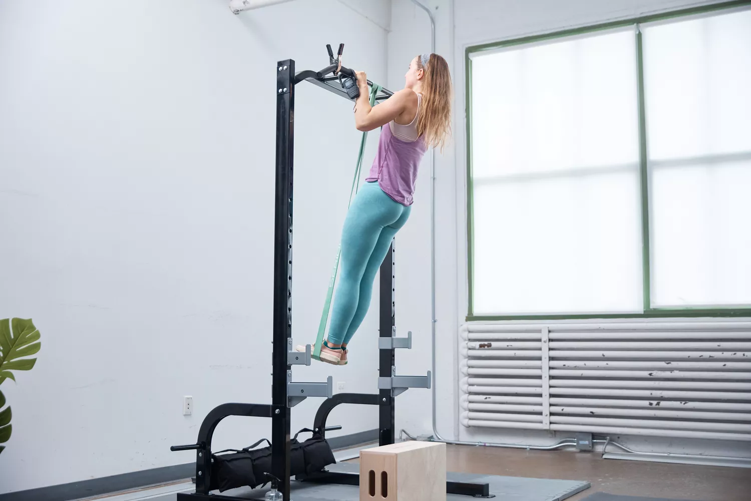 Person using Serious Steel Assisted Pull-up Band to do a pull-up