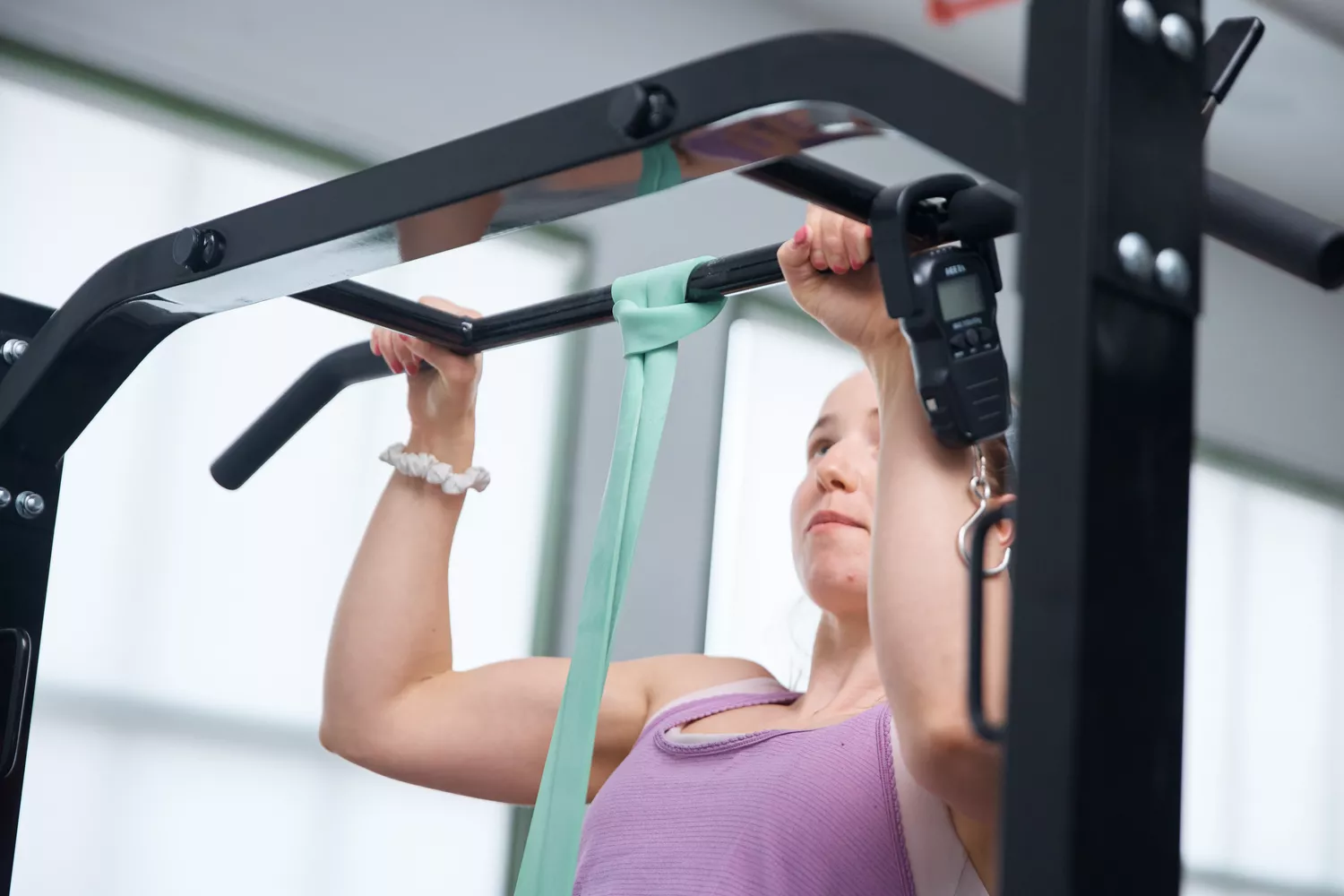 Person using Serious Steel Assisted Pull-up Band to do a pull-up