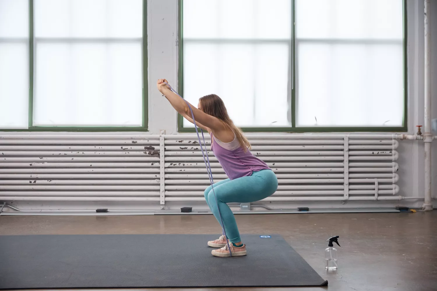 Person doing a squat using Serious Steel Assisted Pull-up Band