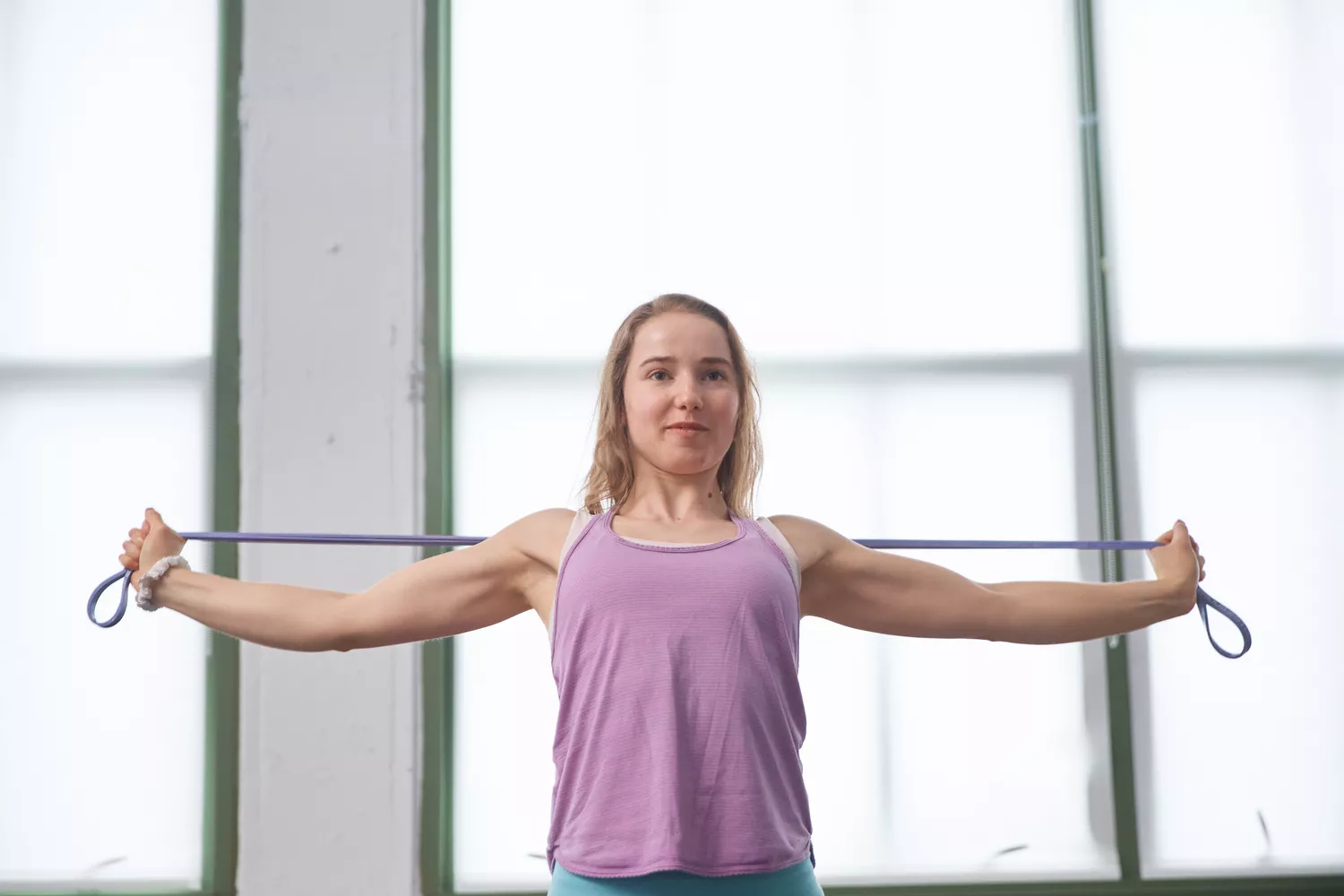 Person using Serious Steel Assisted Pull-up Band to work upper body