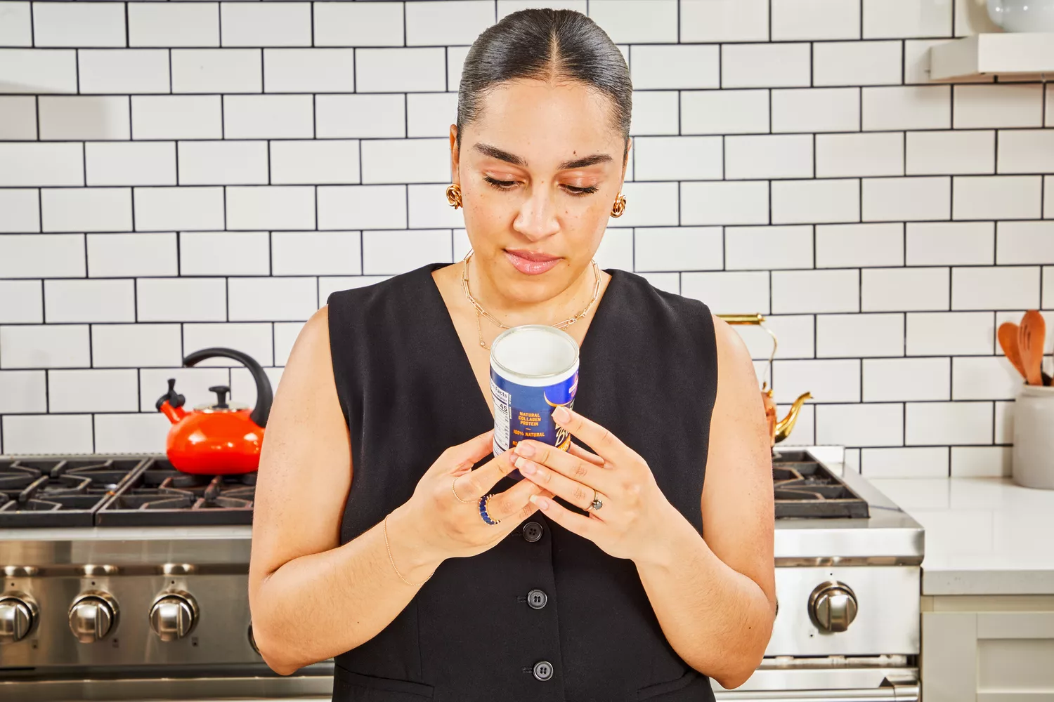 A person reads the label on a container of Swanson Sipping Chicken Bone Broth