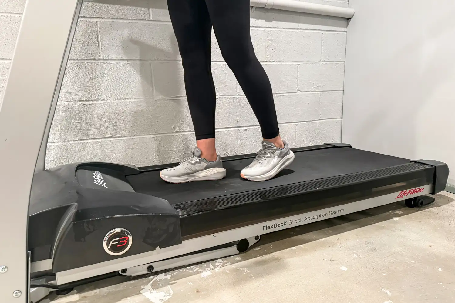 A person walks on a treadmill while wearing the Altra Women's Paradigm 8 Running Shoes