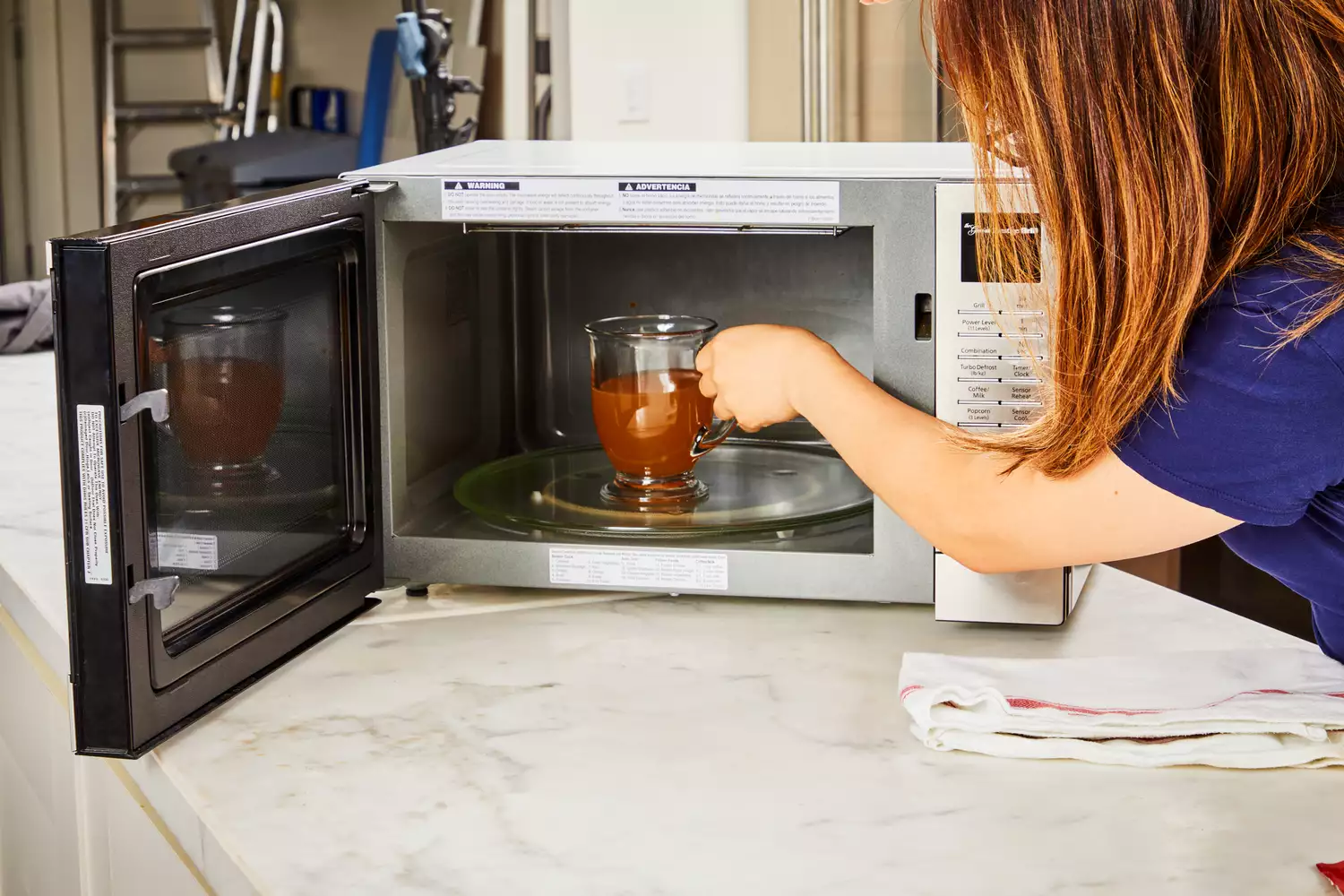 A glass of Brodo Hearth Bone Broth is placed in a microwave