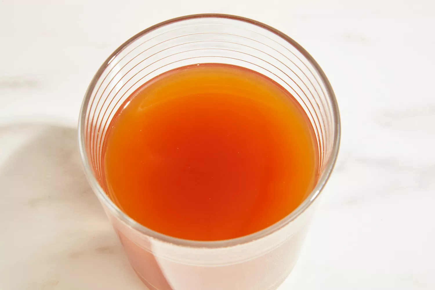 A glass of Bare Bones Bone Broth Instant Powdered Beverage Mix