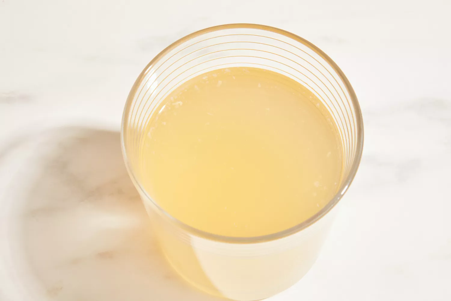A glass of FOND Certified Organic Chicken Bone Broth