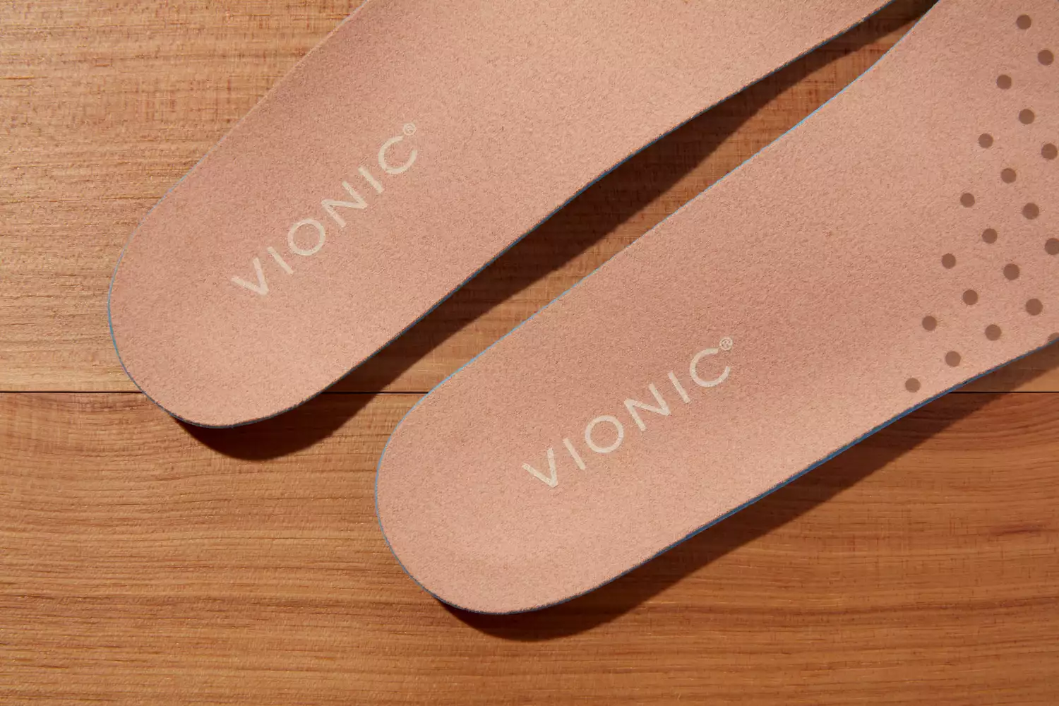 Vionic Slimfit Orthotic Insoles displayed on a wood floor