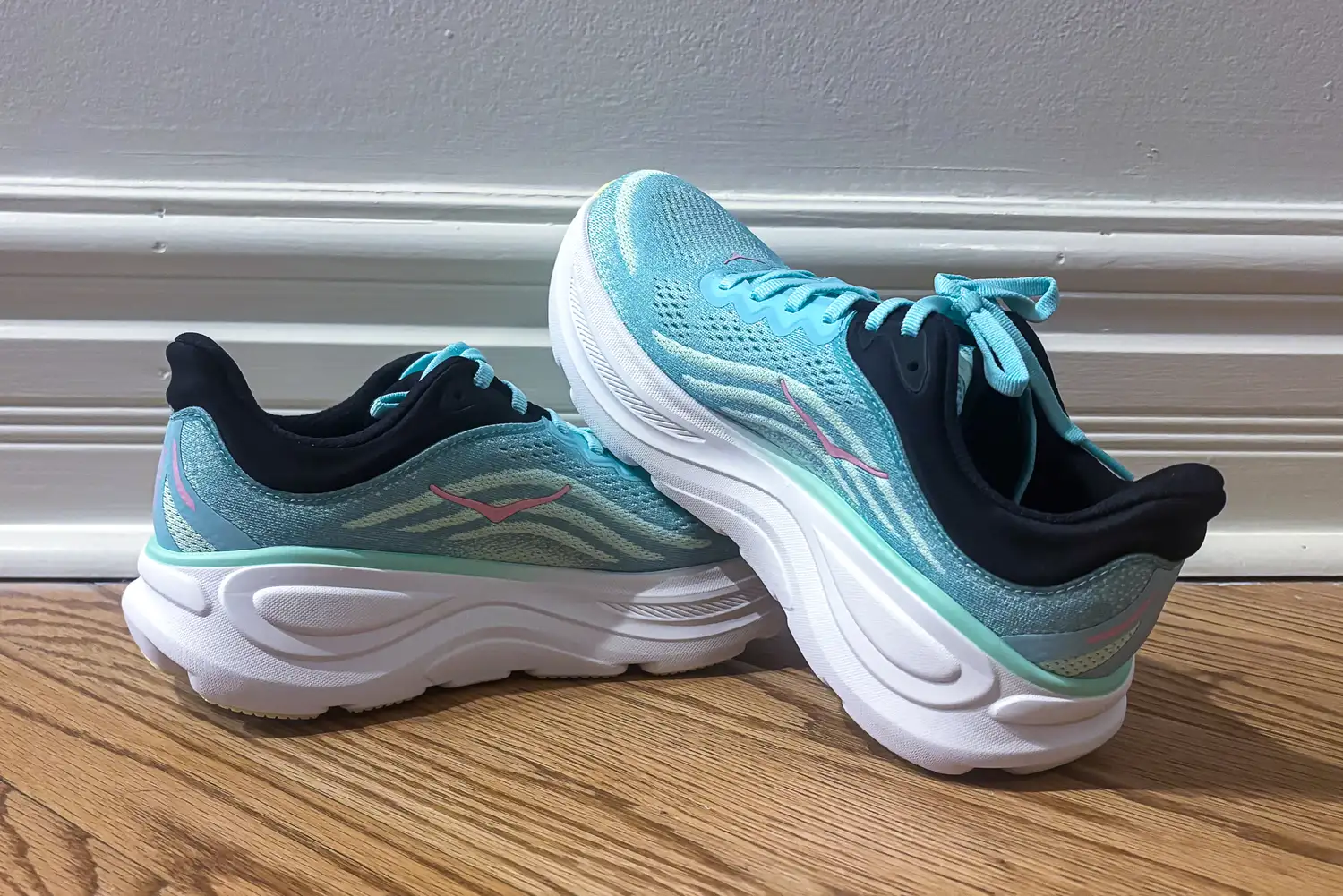 Pair of athletic running shoes on a wooden floor