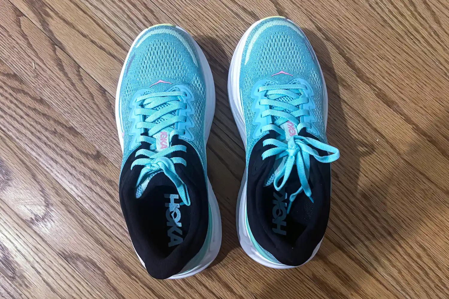 Pair of running shoes on a wooden floor