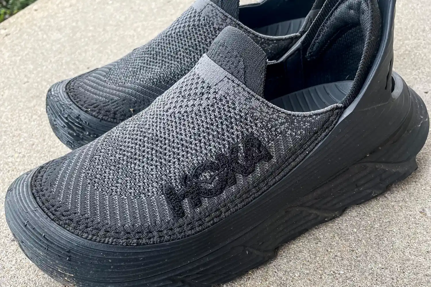 The logo on the side of the Hoka Restore TC Recovery Shoes