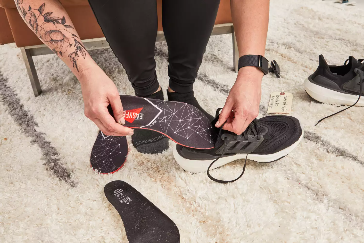 A person putting the EasyFeet Core Energy Insoles for Plantar Fasciitis into a shoe