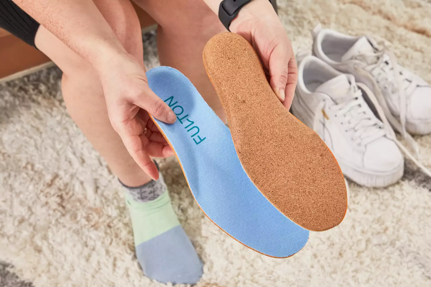 Hands holding Fulton Athletic Insoles