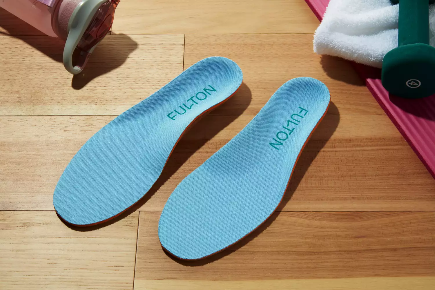 Fulton Athletic Insoles displayed on a wood floor