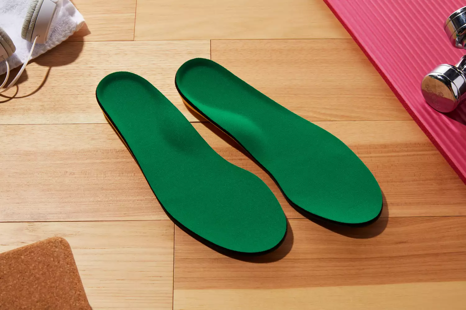 Spenco PolySorb Cross Trainer Insoles displayed on a wood floor