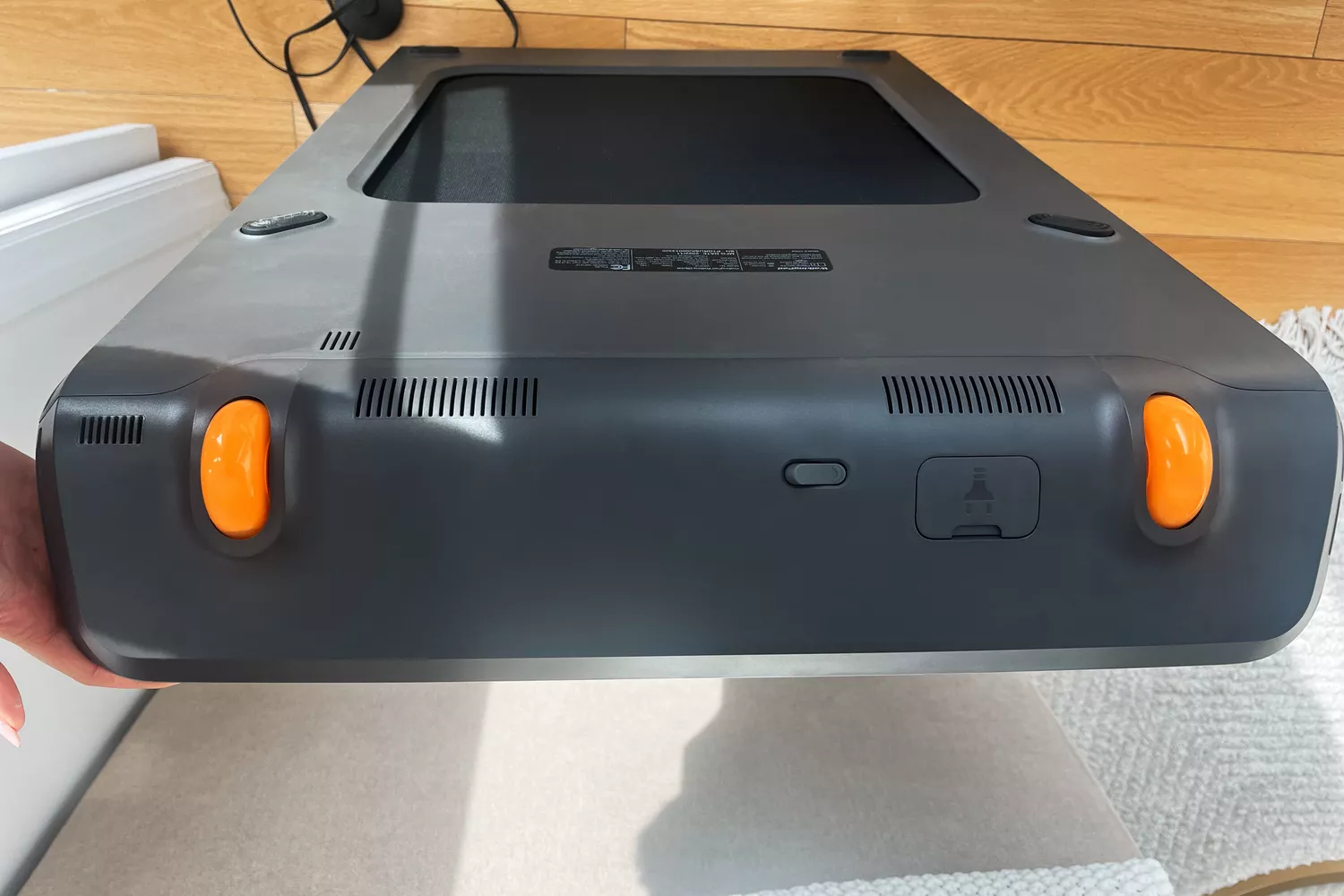 Hand holding end of WalkingPad P1 Foldable Walking Treadmill