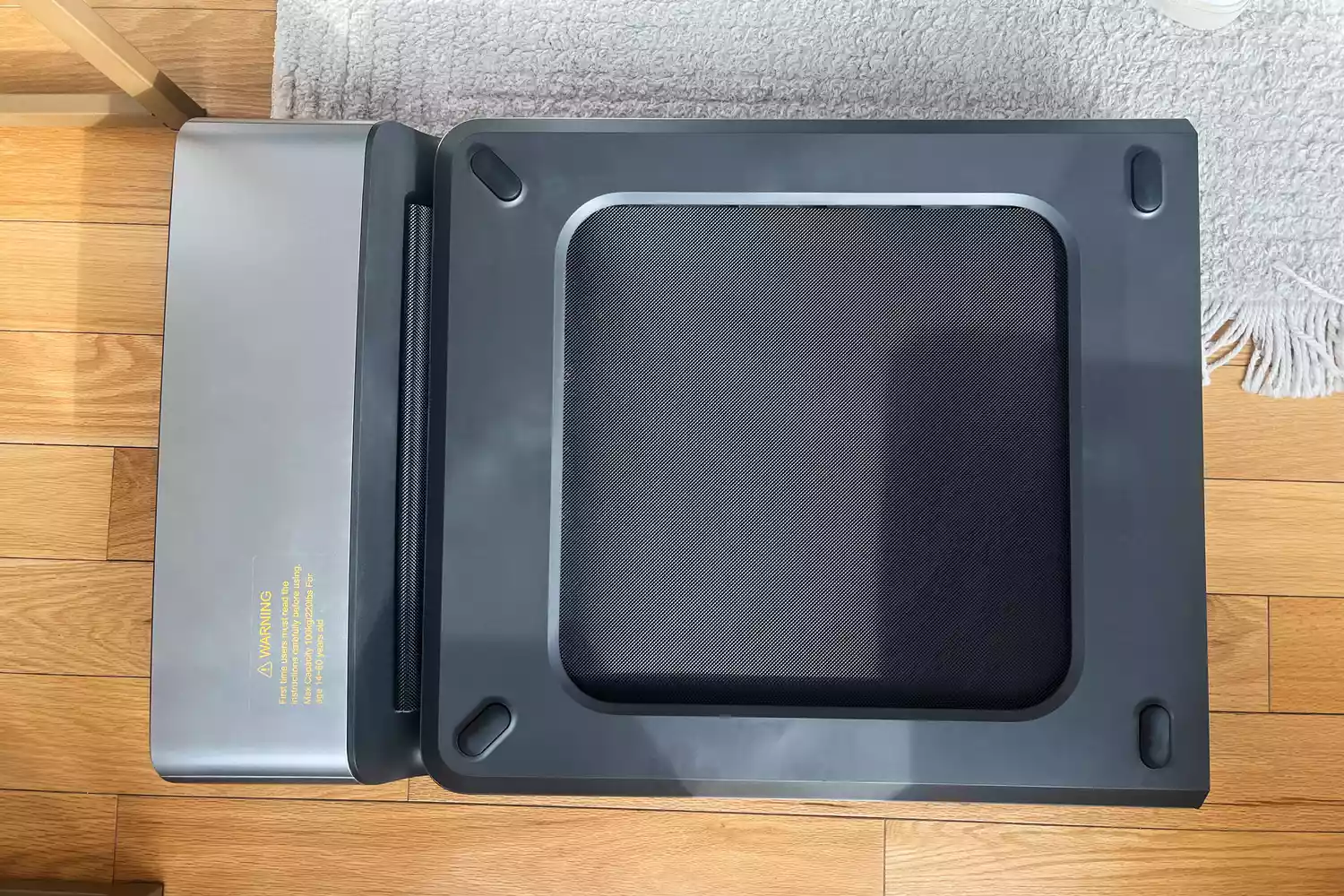 WalkingPad P1 Foldable Walking Treadmill folded up on wood floor