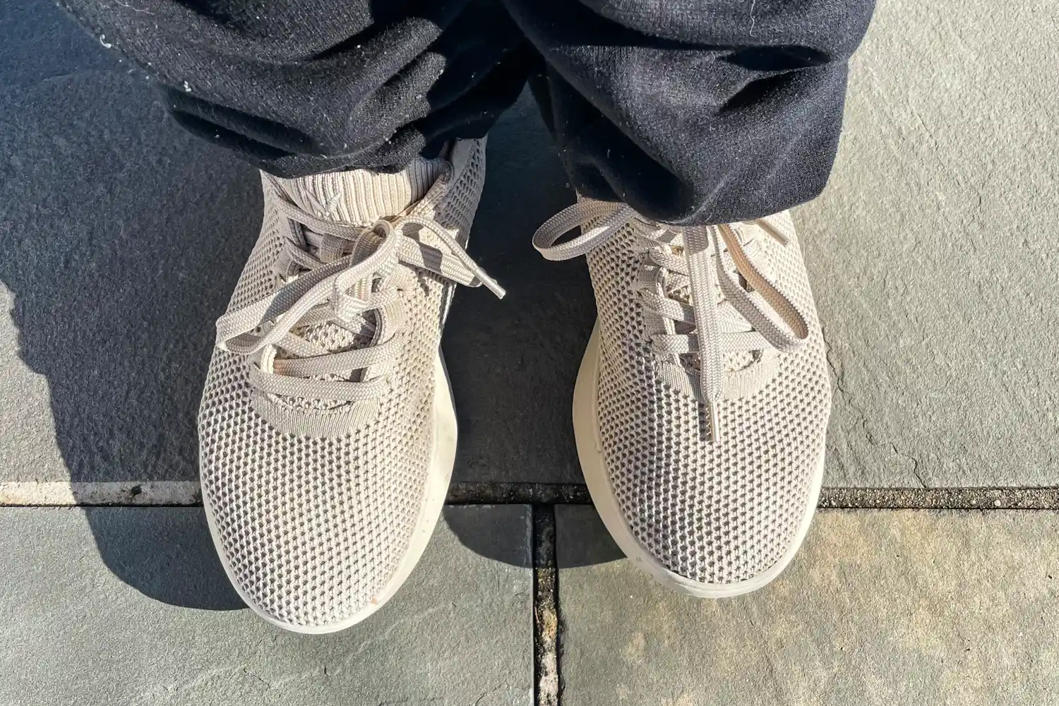 A person stands outside while wearing the Vivaia Unisex Urban Sneaker Sliders