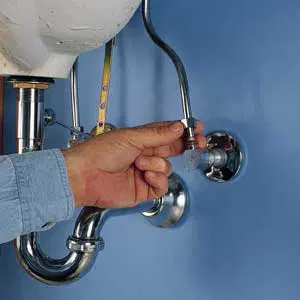 An image of a man installing an angle-stop valve.