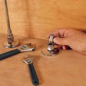 a straight-stop valve, pipe-joint compound, and two adjustable wrenches.