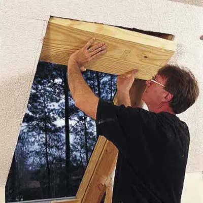 finishing the interior of a skylight by installing a wood header