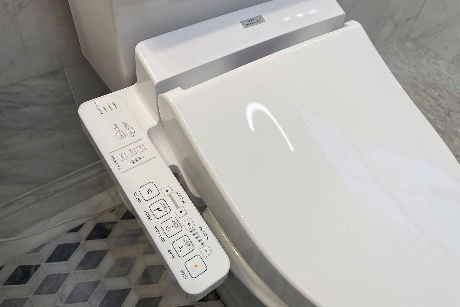 Closeup of Toto C100 Washlet Electronic Bidet Toilet Seat installed on a toilet