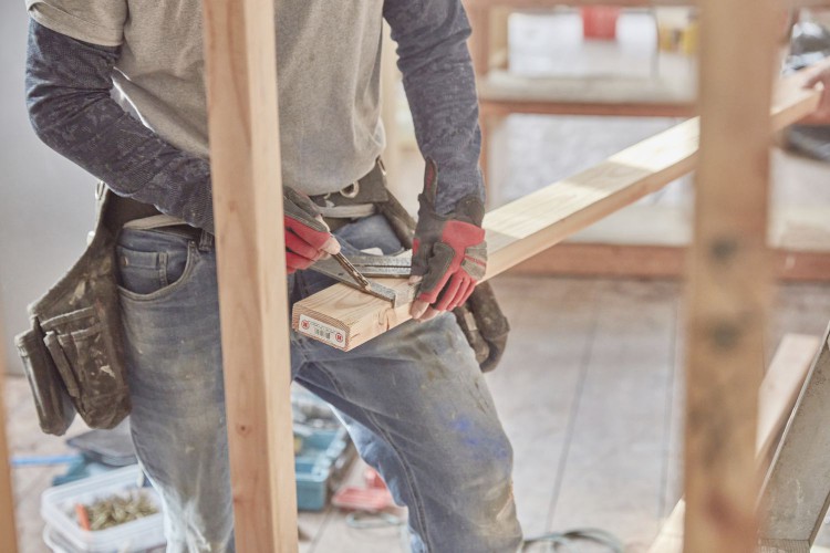 Contractor measuring beam for kitchen remodel