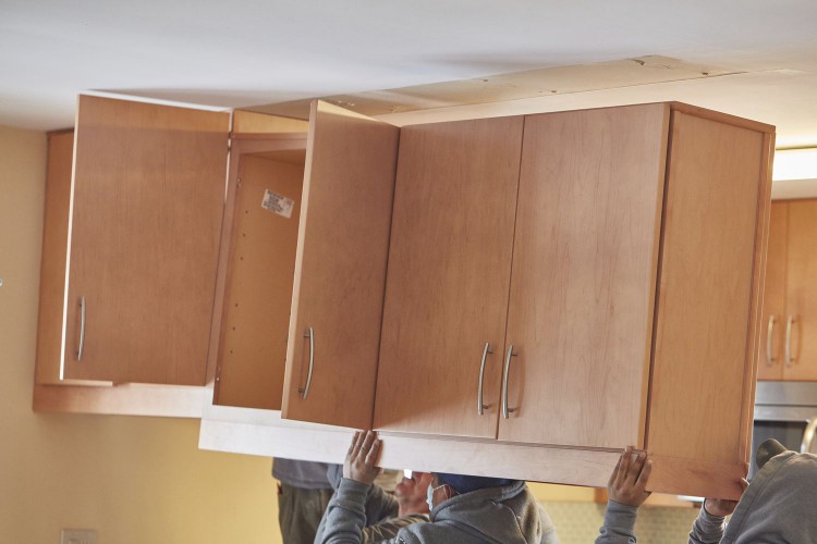 Wooden cabinets being removed for kitchen remodel