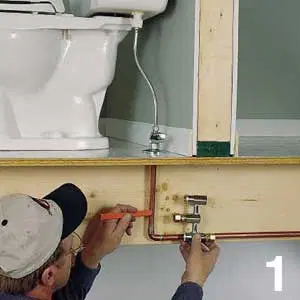 Man marking where the center outlet port aligns with pipe.