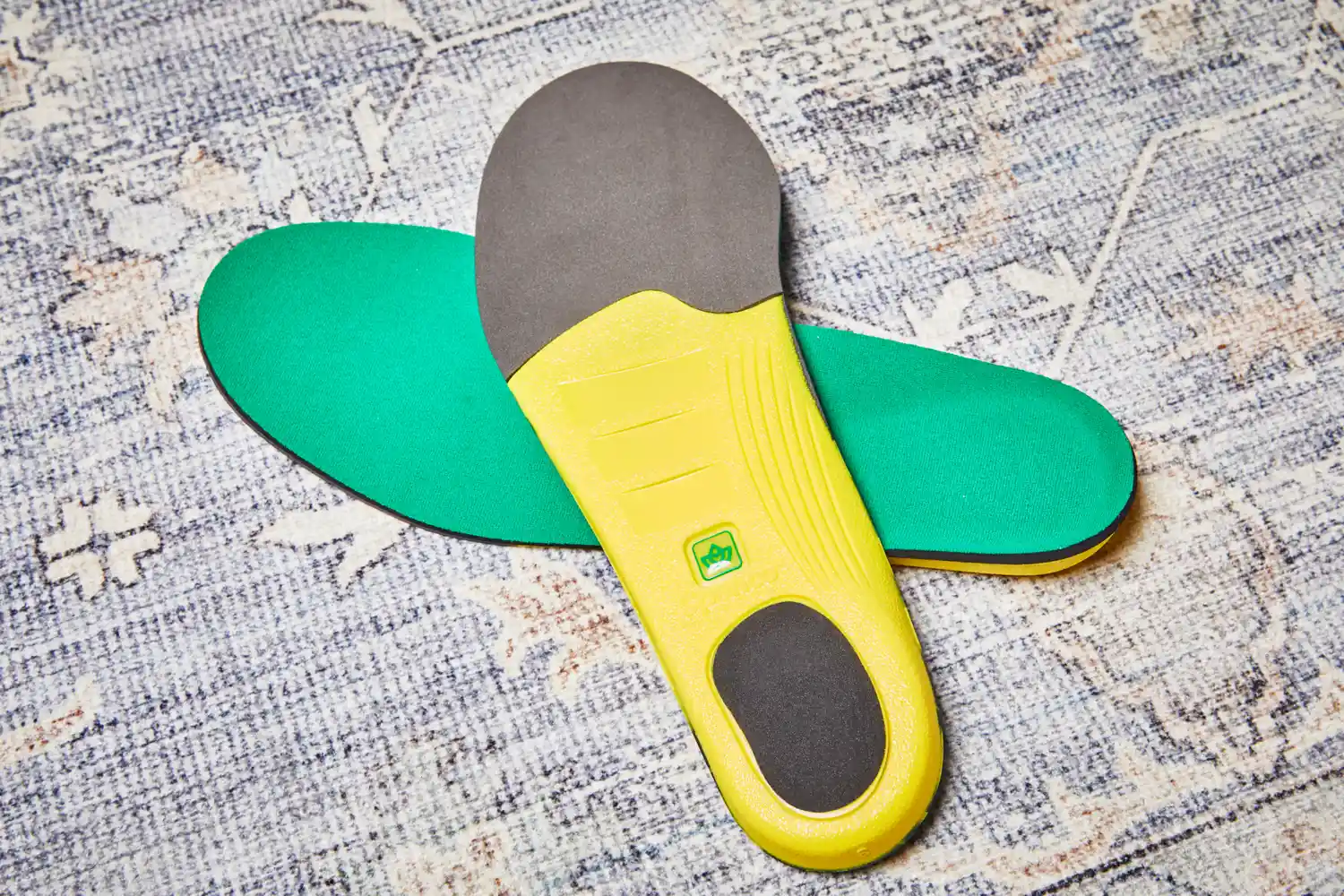 Spenco PolySorb Cross Trainer Insoles displayed on carpet