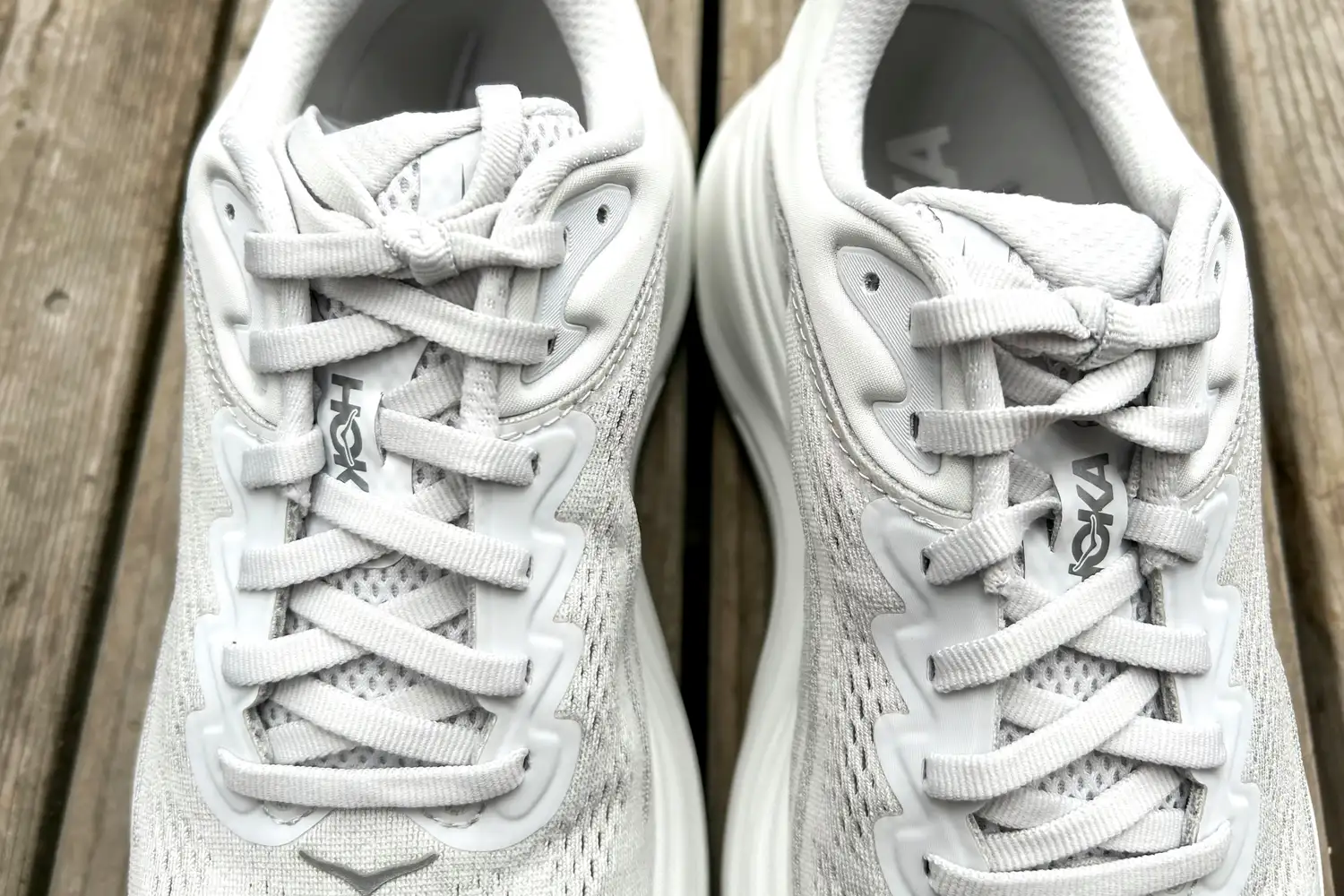 A close-up of the laces on the Hoka Bondi 9 shoes placed on wood