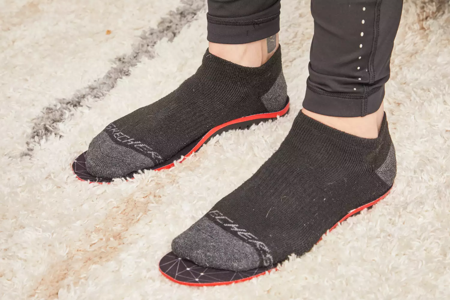 Feet in socks standing on EasyFeet Plantar Fasciitis Arch Support Insoles