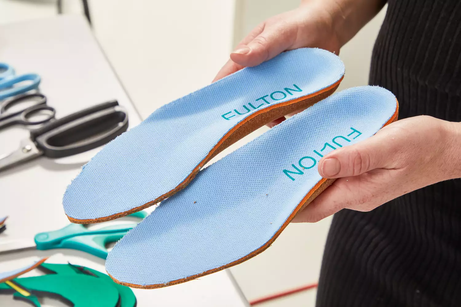 Hands holding Fulton Athletic Insoles