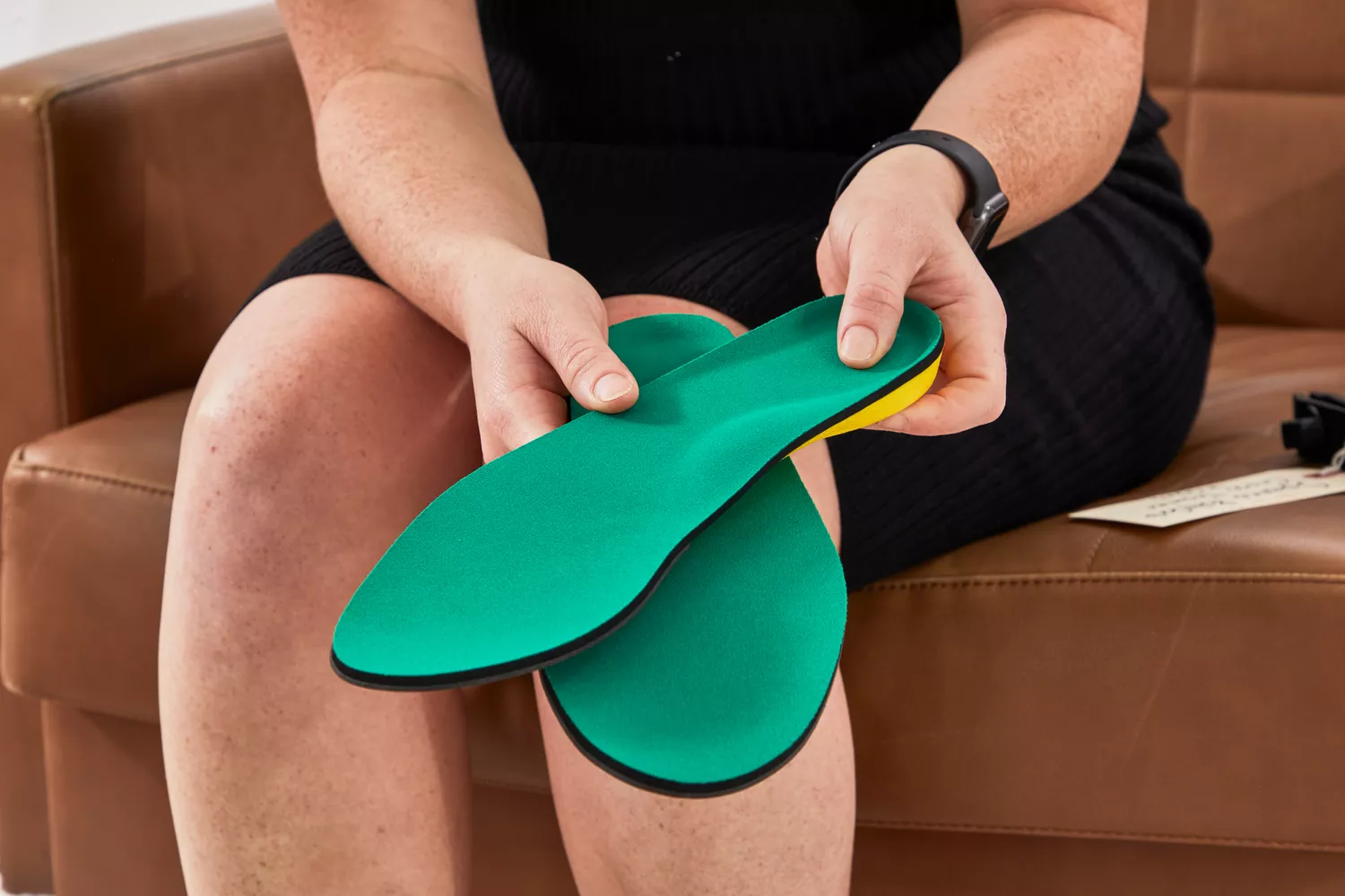 Person holding Spenco PolySorb Cross Trainer Insoles