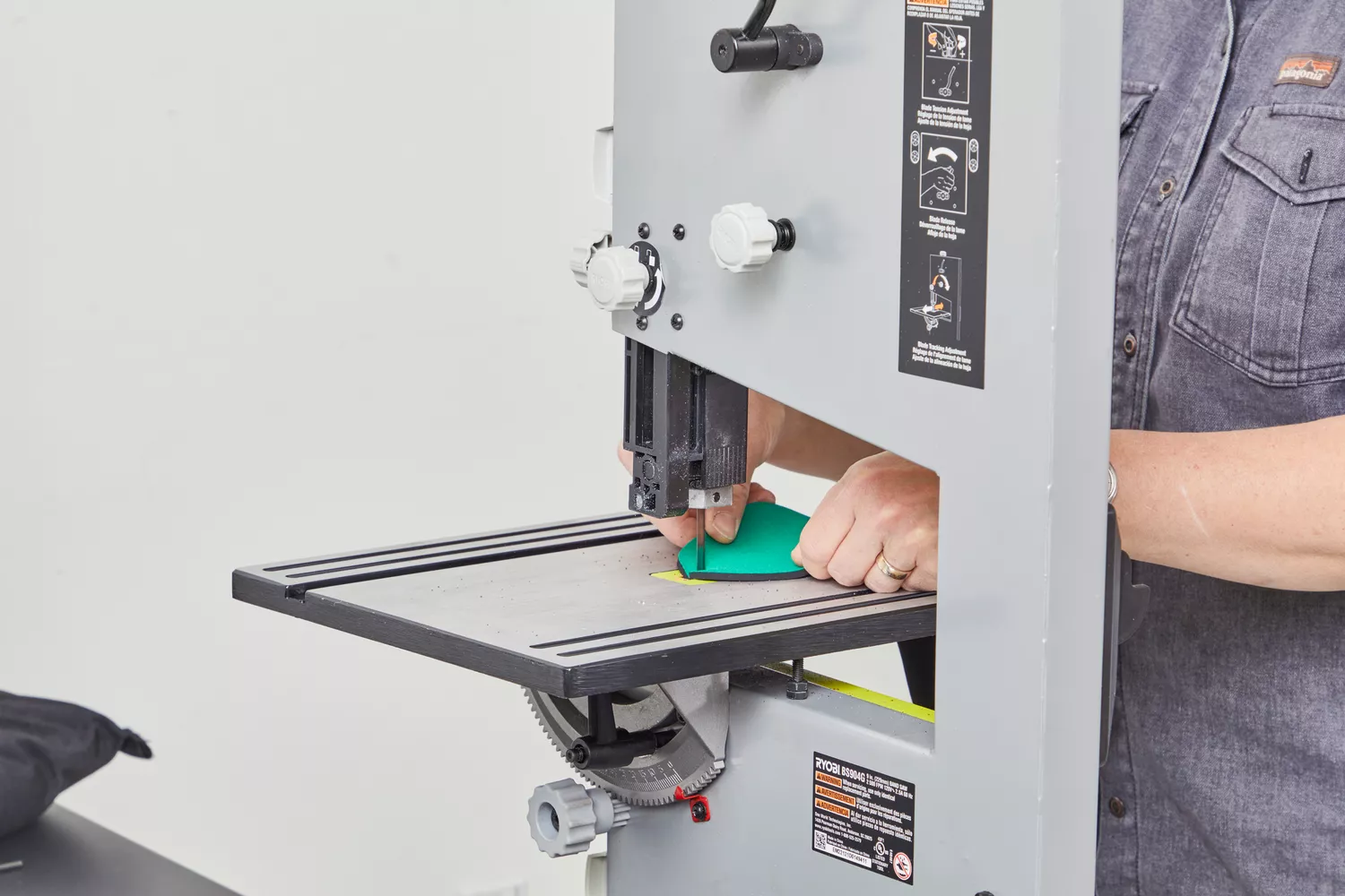 Person cutting a Spenco RX Comfort Insole in half with a band saw