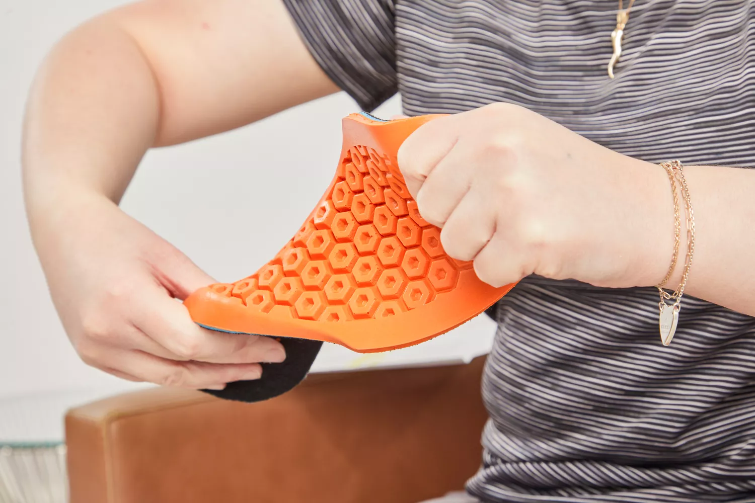 Hands twisting a Timberland Pro Anti-Fatigue Technology Insole