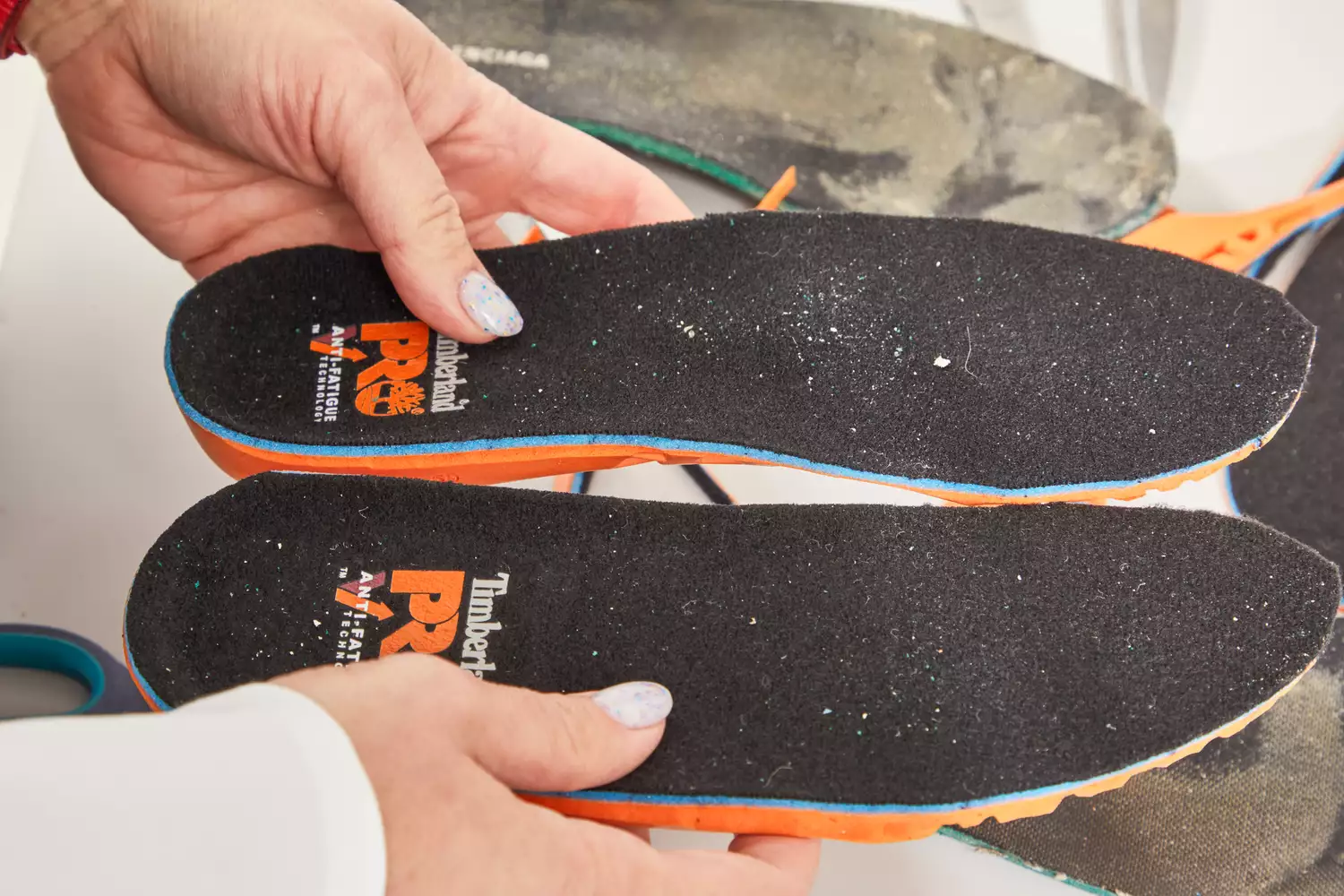 Hands holding Timberland Pro Anti-Fatigue Technology Insoles