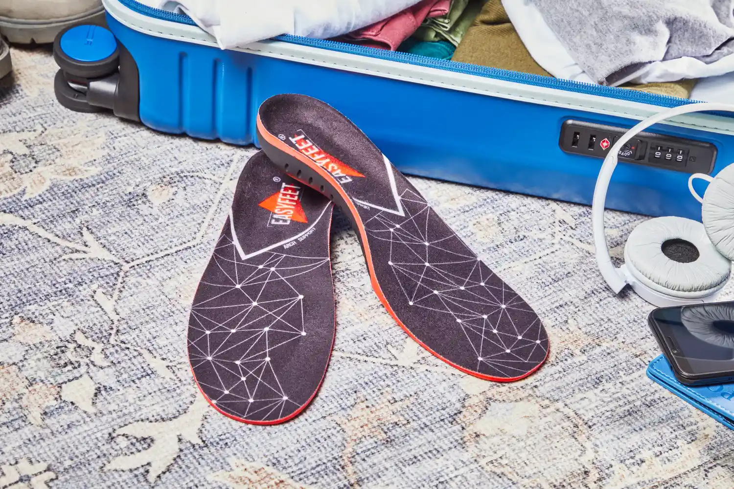 EasyFeet Plantar Fasciitis Arch Support Insoles displayed next to a suitcase
