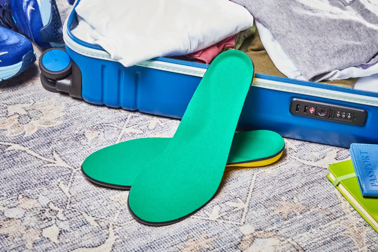 Spenco PolySorb Cross Trainer Insoles displayed with a suitcase