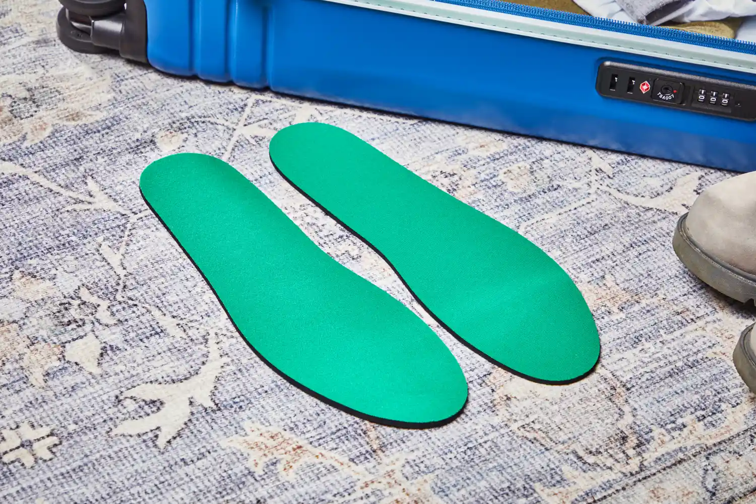 Spenco RX Comfort Insoles displayed in front of a suitcase