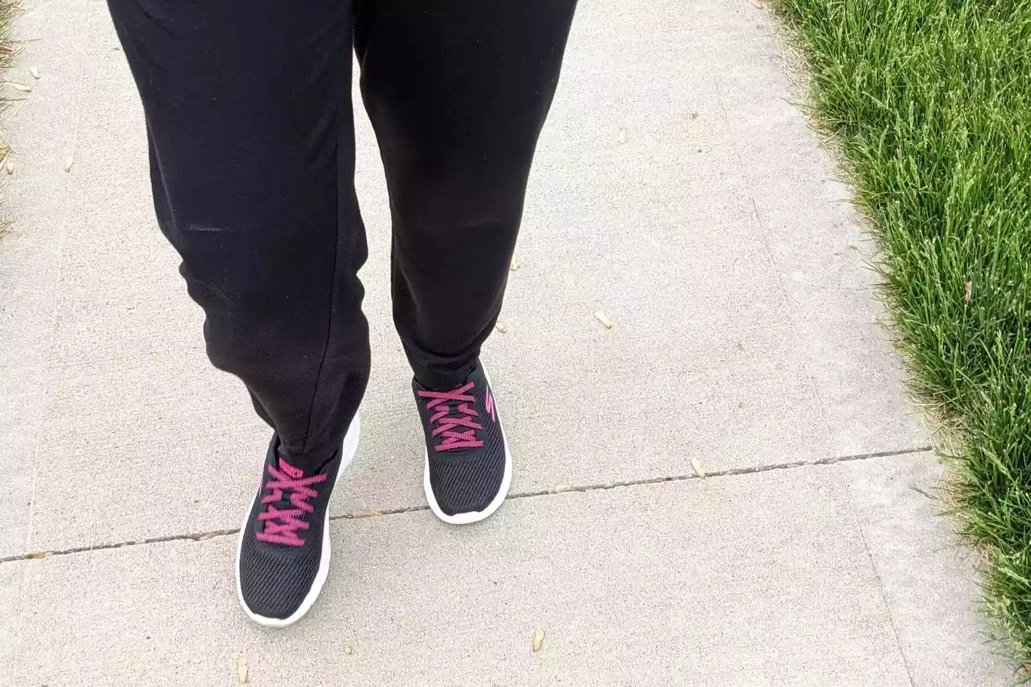 A person wearing the Skechers Women's Go Walk Flex-Alani Sneaker