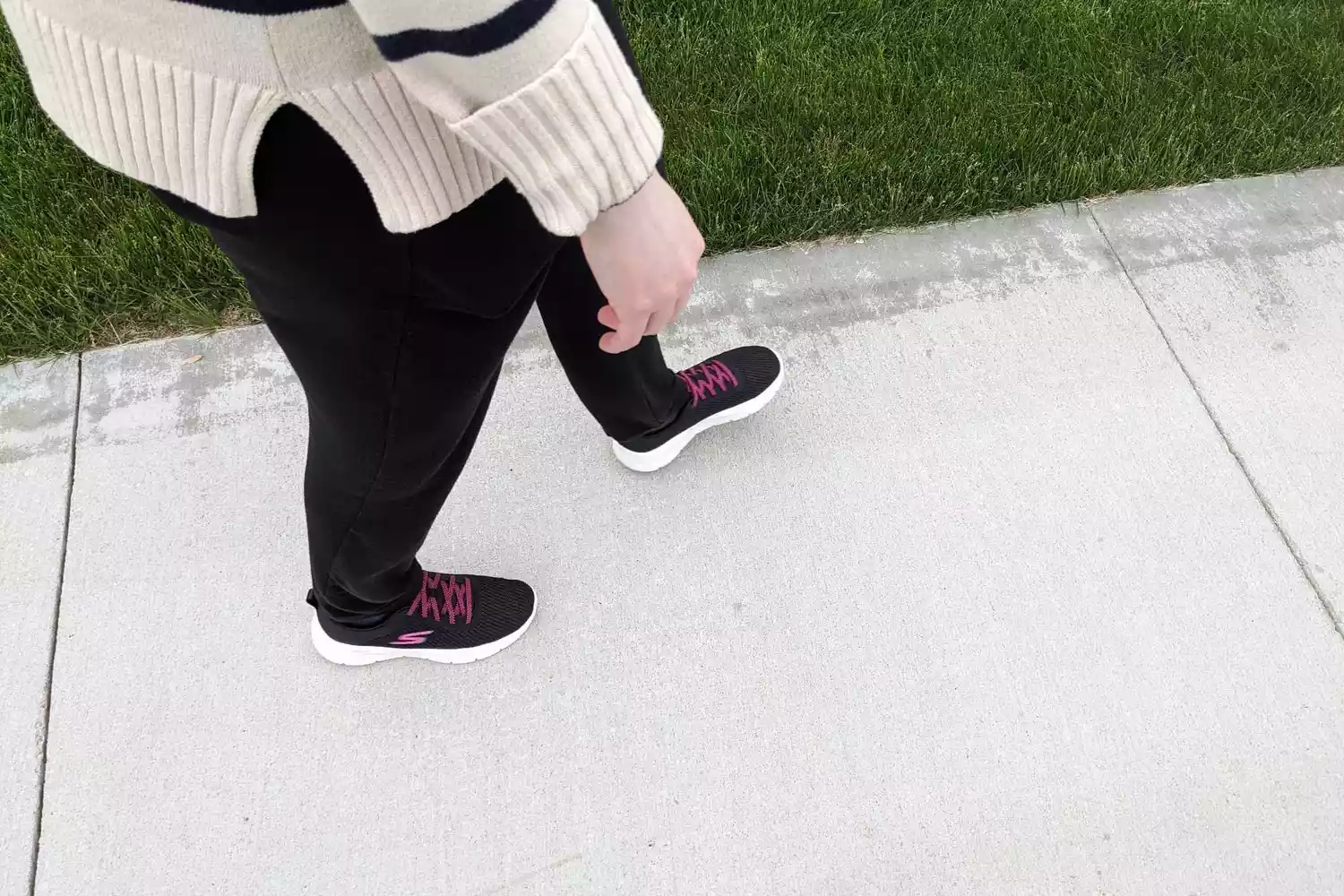 A person wearing the Skechers Women's Go Walk Flex-Alani Sneaker