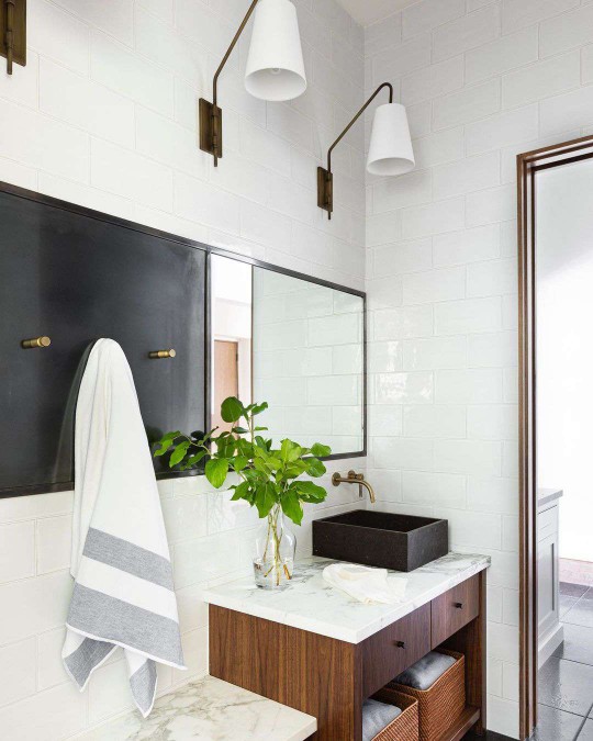 A bathroom with a black and gold towel hanging rack