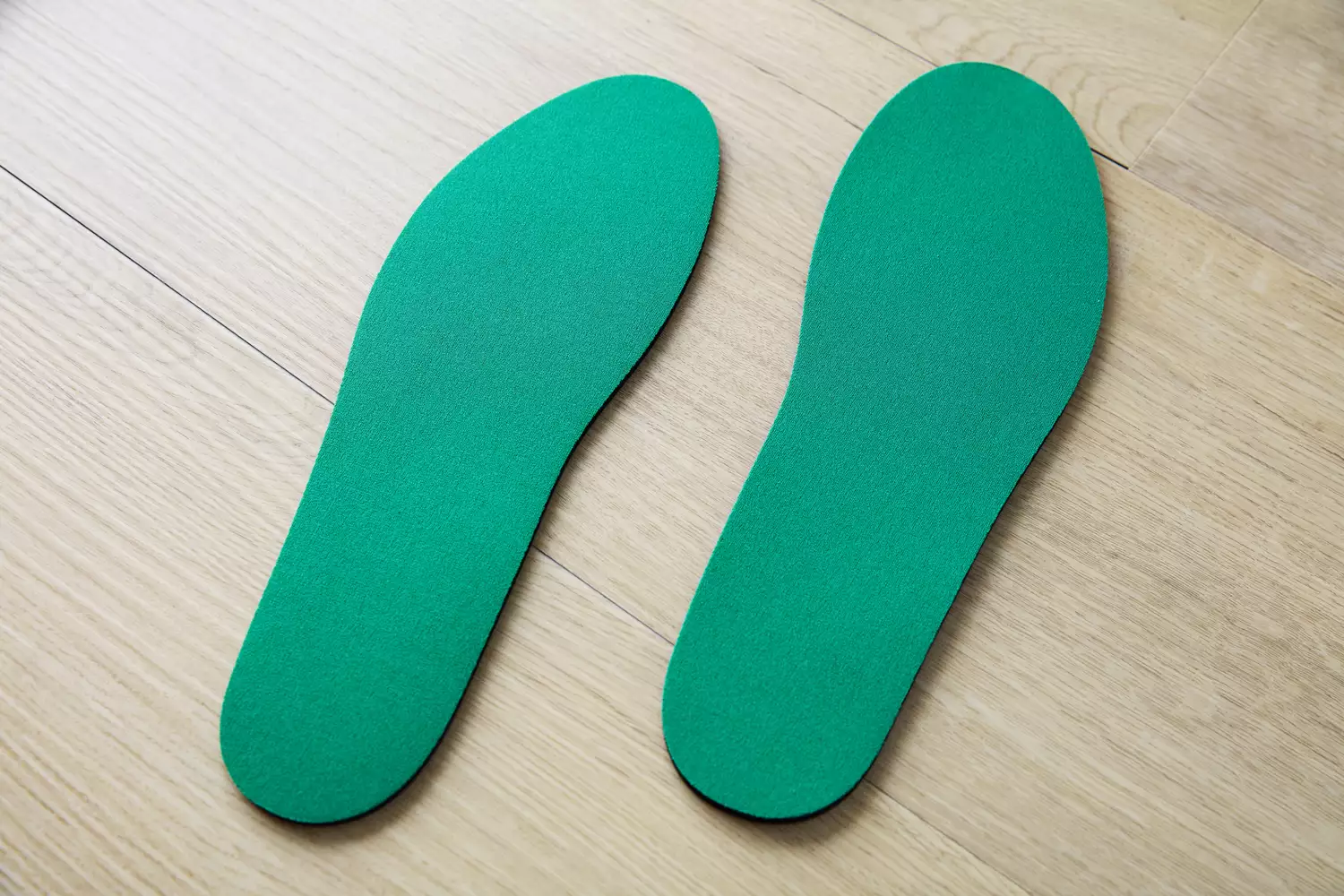 Spenco RX Comfort Insoles displayed on a wood floor
