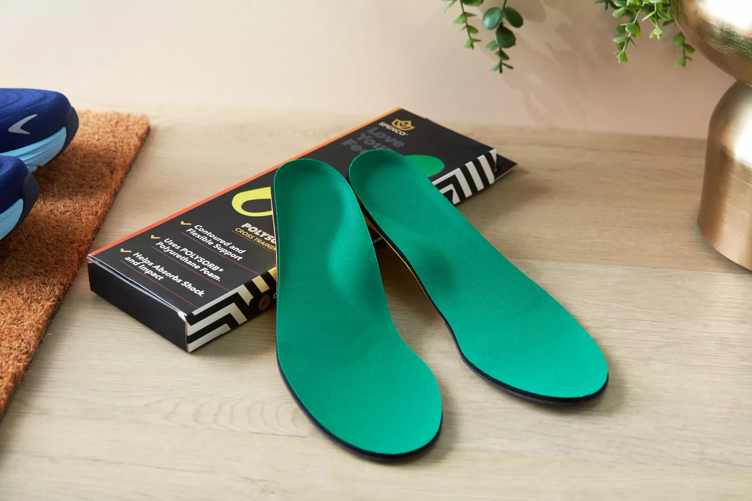Spenco PolySorb Cross Trainer Insoles displayed on a wood surface with product box