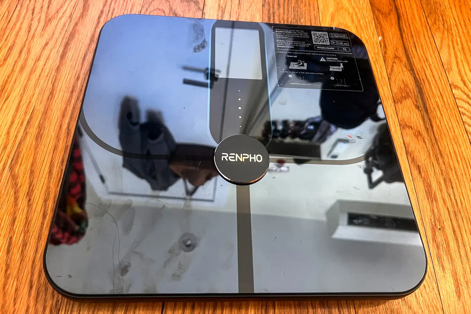 The Renpho Elis Nova Smart Scale on a wooden floor