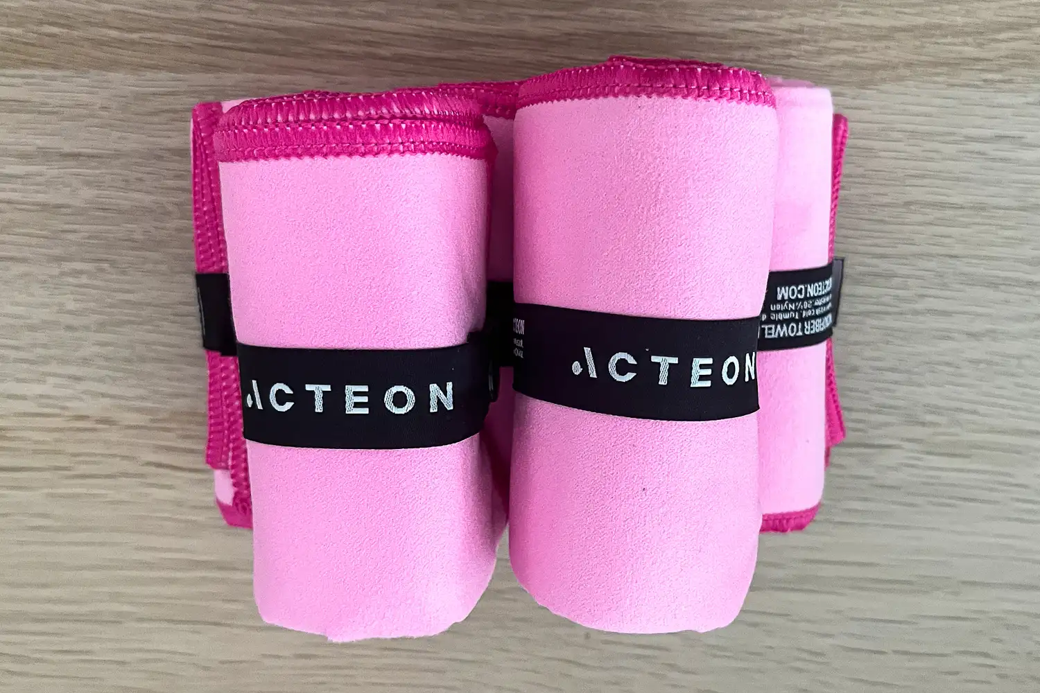 Several Acteon Microfiber Quick Dry Gym Towels rolled up and stacked