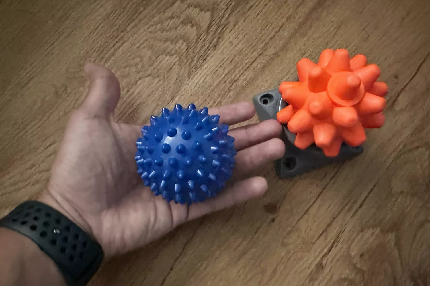 Small spiked blue and orange ball accessories from the CXCTCT Extra-Long Yoga Acupressure Mat Set