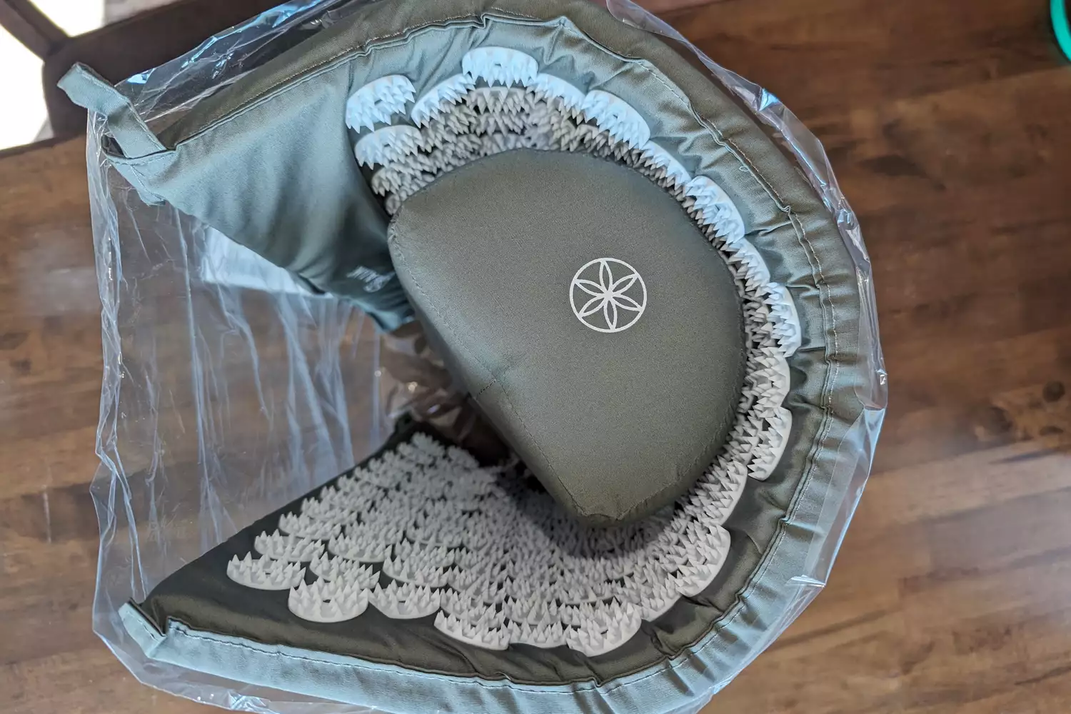 Above view of rolled up Gaiam Acupressure Mat and Pillow Set in clear packaging