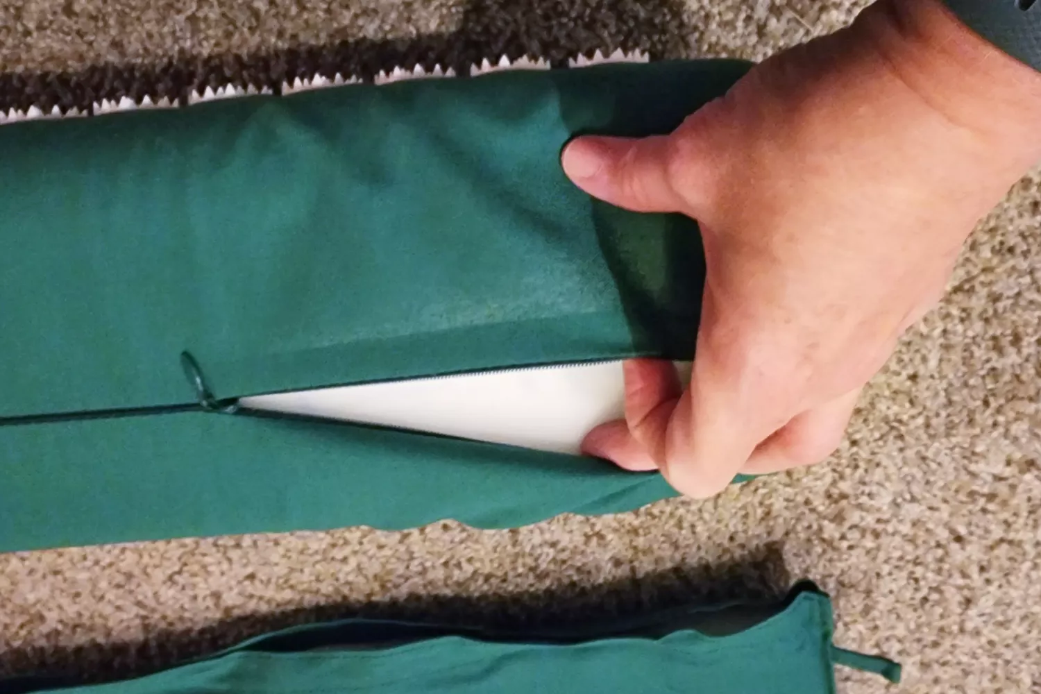 Closeup opening the zipper of the Sivan Back and Neck Pain Relief Acupressure Pillow